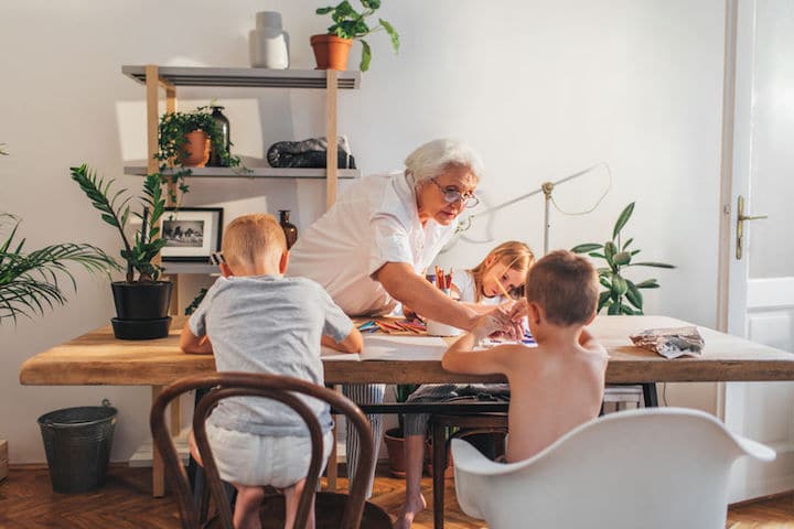 Grandma and grandchildren play and paint at home