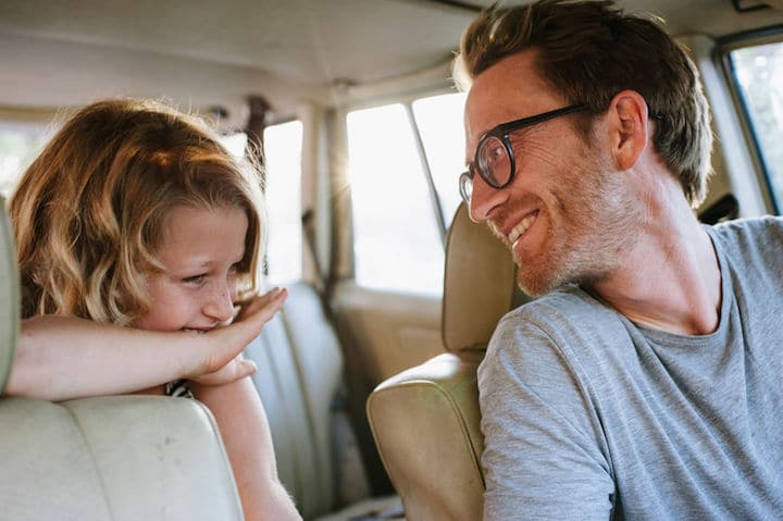 Dad And Daughter Laughing In Car Together