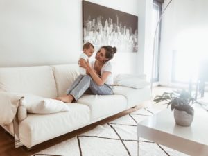 Mom smiles at her baby at home.