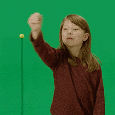 Gif of a child in front of a green screen.