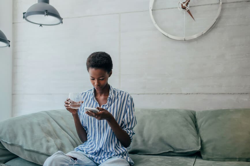 Beautiful african american woman shopping online from home