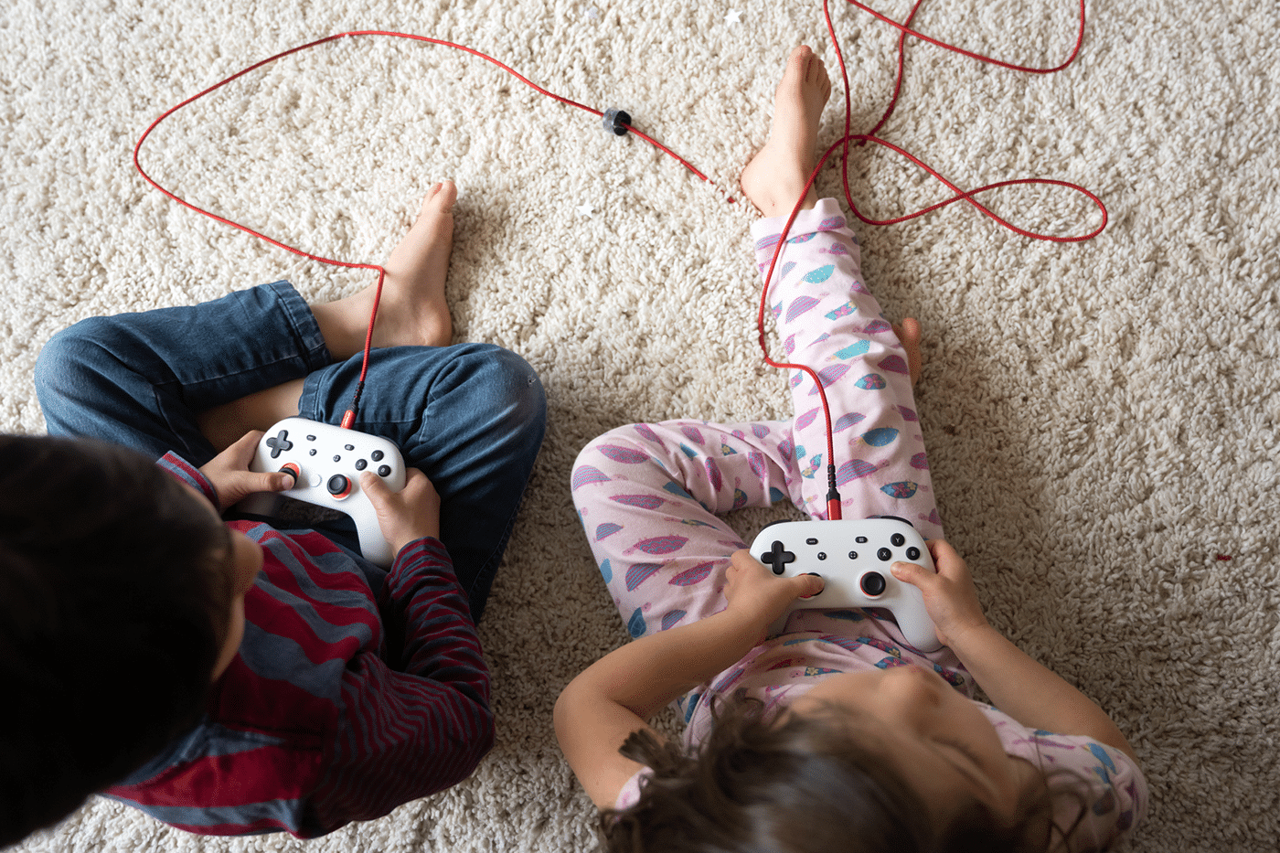 Overhead shot of kids playing video games, holding controller