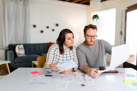 A couple prepares their tax information for filing from the comfort of their home.